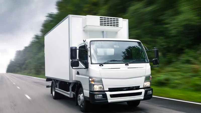 Refrigeration truck body vehicle driving on road with insulated cargo box and cooling unit for cold chain transport